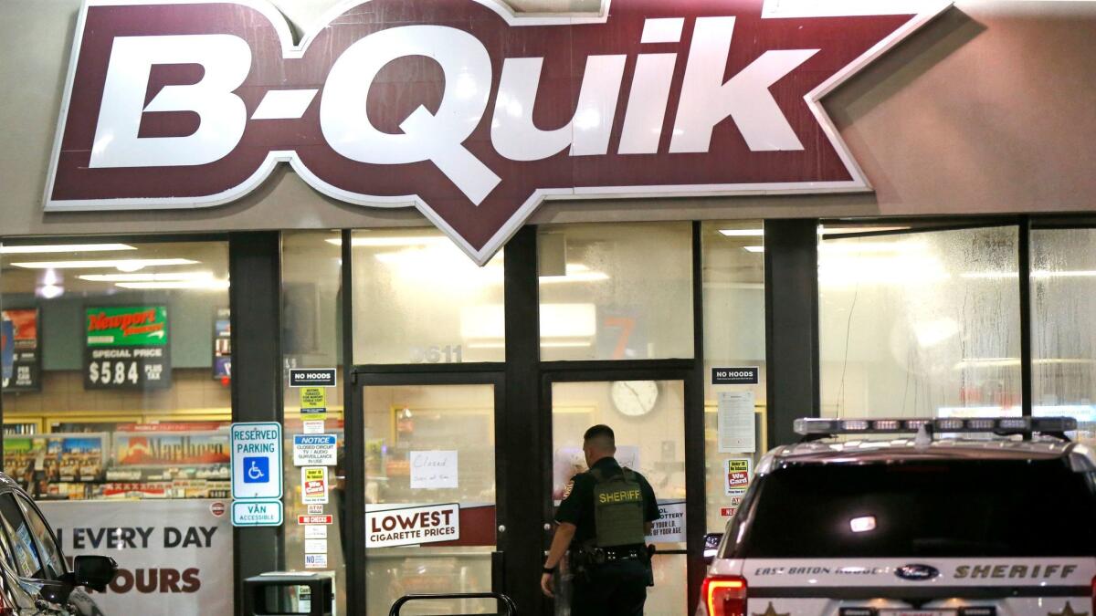 An East Baton Rouge Sheriff's officer enters the B-Quick convenience store at the shooting scene in Louisiana where several officers were either shot or killed on July 17, 2016.