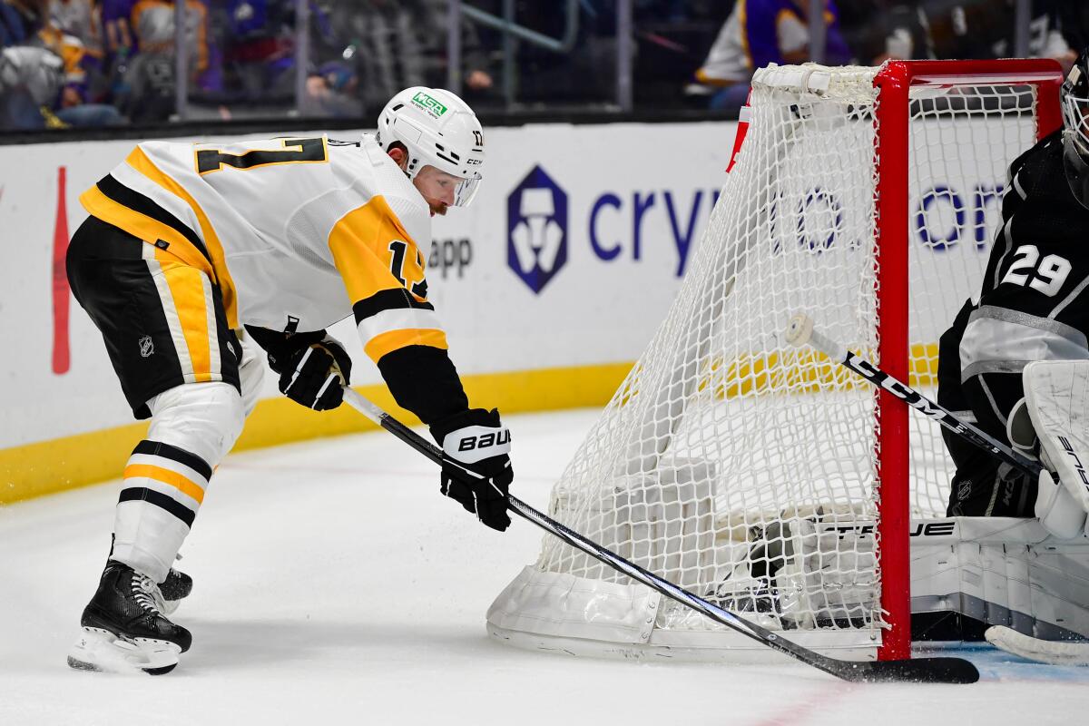 Pittsburgh Penguins forward Bryan Rust scores on a wraparound past Kings goalie Pheonix Copley.