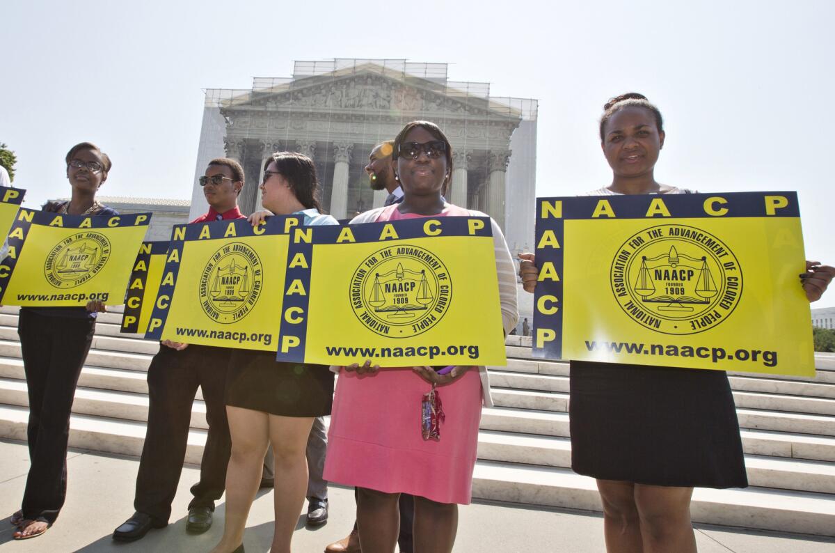 Representatives from the NAACP Legal Defense Fund protest outside the Supreme Court in June.
