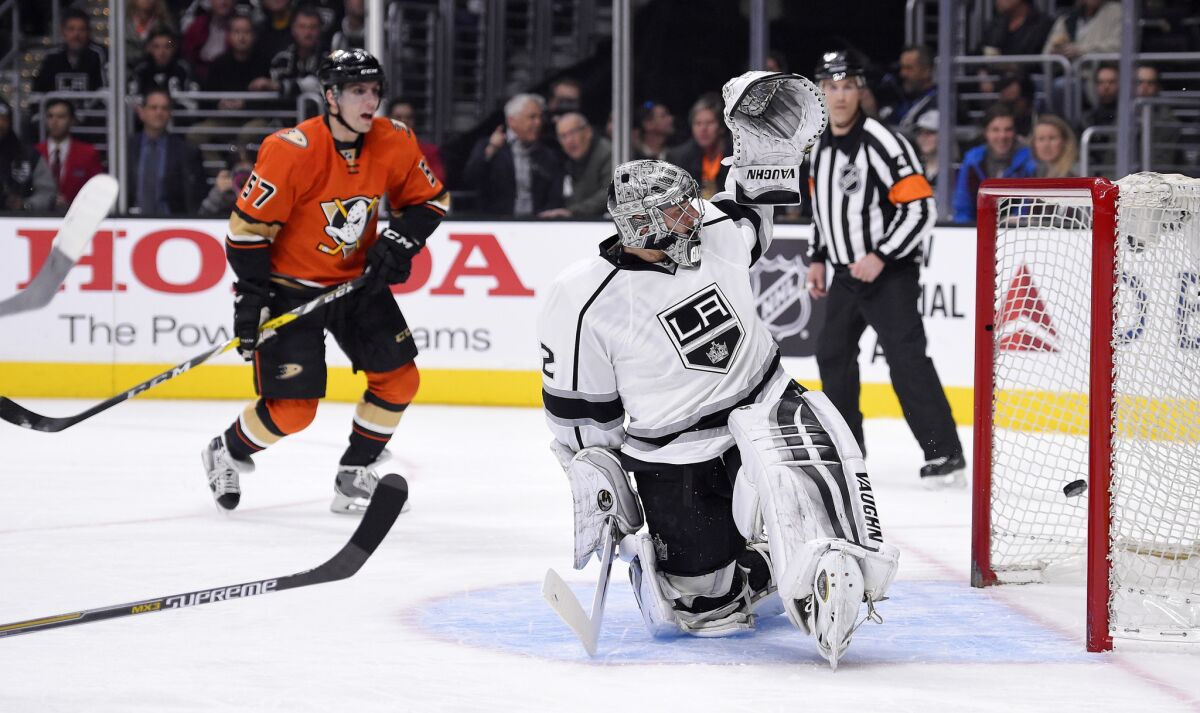 Ducks forward David Perron (57) watches as Kings goalie Jonathan Quick is scored on by Ducks center Ryan Getzlaf during the first period.