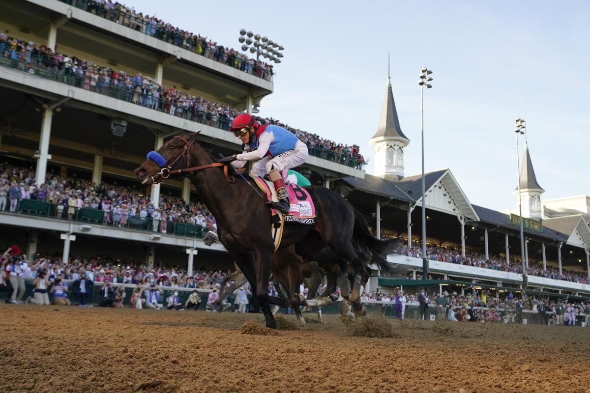 FILE - John Velazquez rides Medina Spirit across the finish line to win the 147th running of the Kentucky Derby at Churchill Downs in Louisville, Ky., Saturday, May 1, 2021. Medina Spirit, controversial winner of the Kentucky Derby, and Belmont Stakes winner Essential Quality head a field of 10 horses for the Breeders’ Cup Classic. (AP Photo/Jeff Roberson, File)
