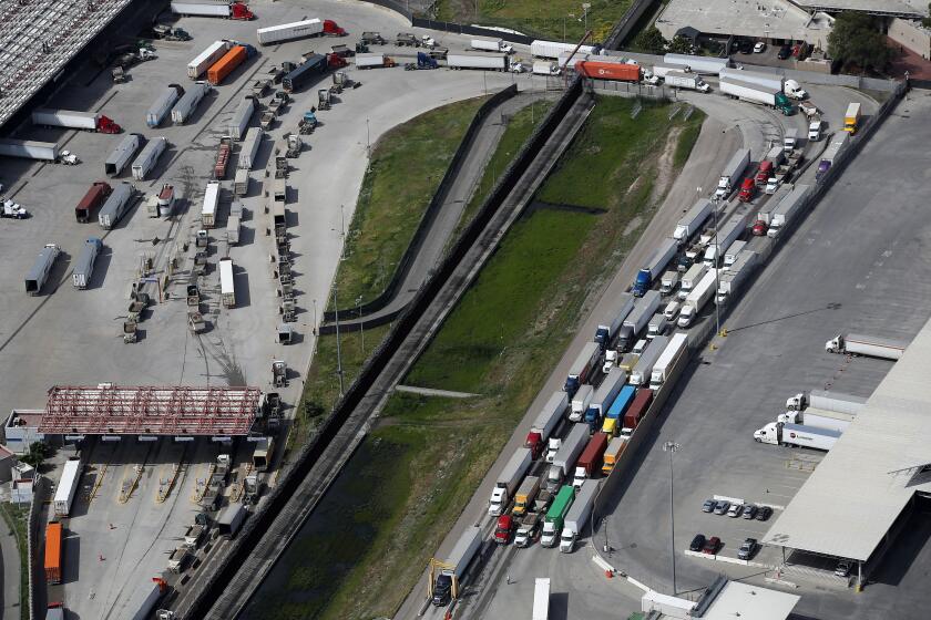 SAN DIEGO, CALIFORNIA - MARCH 20: Commercial freight trucks line up to cross into the United States from Mexico through the U.S. Customs and Border Protection - Otay Mesa Port of Entry during the coronavirus (COVID-19) pandemic on March 20, 2020 in San Diego, California. The United States and Mexico announced a temporary ban on non-essential and leisure travel across the U.S. - Mexican border, but both countries emphasized that trade activity would not be impacted. (Photo by Sean M. Haffey/Getty Images)
