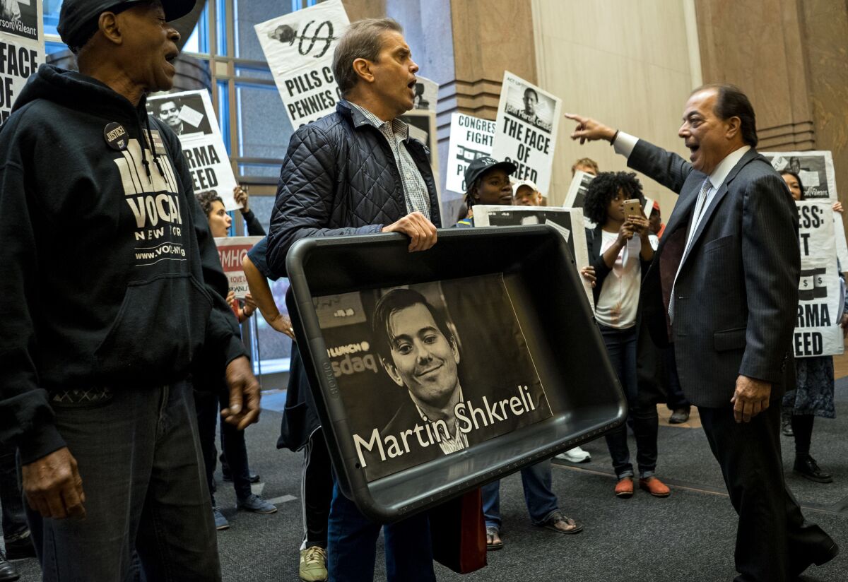 Not the most popular guy in the world: A protester carrying a cat litter box lined with an image of Turing Pharmaceuticals CEO Martin Shkreli appears at Turing's New York offices in October.