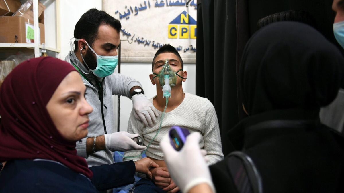 A Syrian boy is treated in Aleppo on Saturday following what Syria and Russia say was a rebel-launched chemical attack. Rebels said the attack was a false flag operation meant to give Syria and Russia cover to attack.