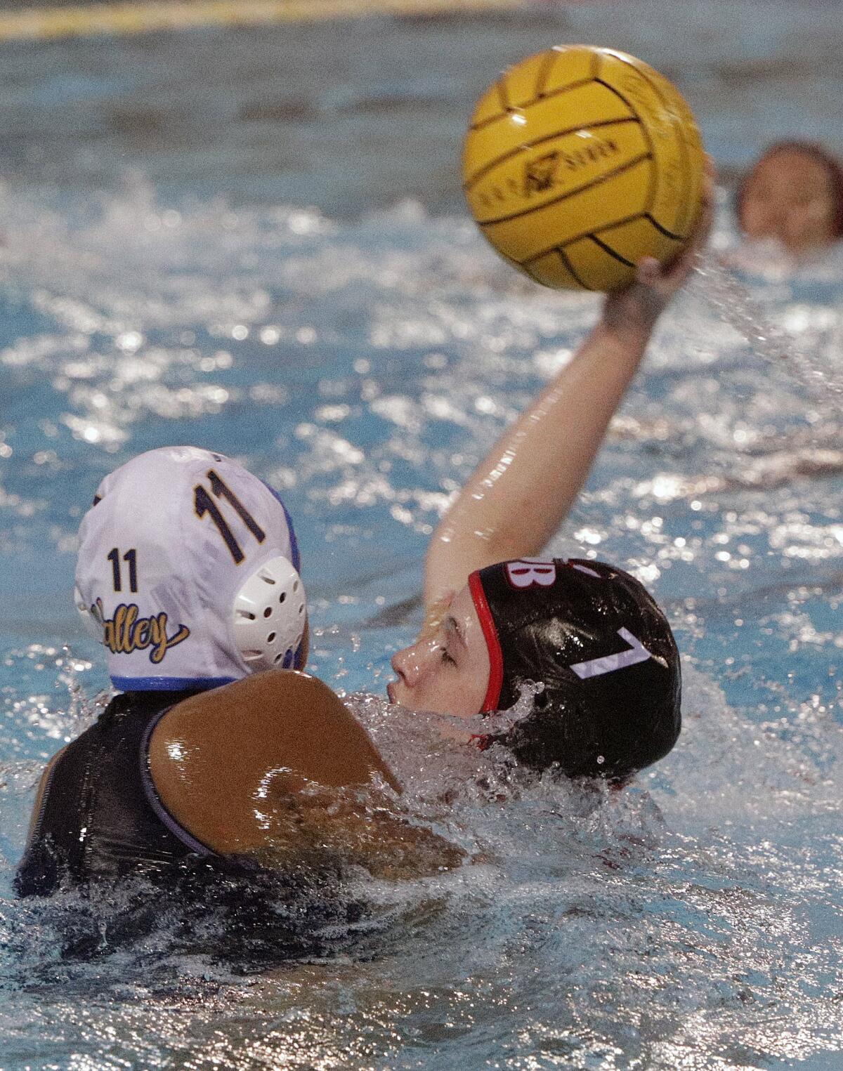 Burroughs' Nancy Baylor, begin defended by Santa Ana's Guadalupe Ayala, leans back to shoot in the first round of the CIF Southern Section Division V girls' water polo playoffs at Burroughs High School on Tuesday, February 11, 2020. Burroughs won the game and advances.