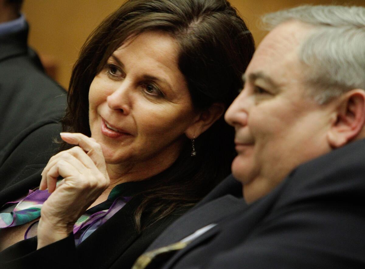 Former Bell Assistant City Administrator Angela Spaccia confers with her former boss in 2011.