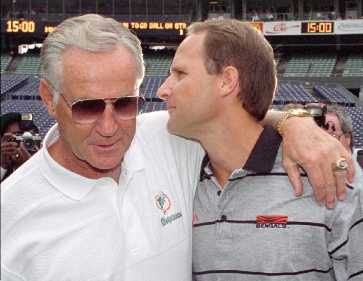 FILE -- Miami Dolphins head coach Don Shula, left, meets with his son, Cincinnati Bengals head coach Dave Shula, before the start of their game in Cincinnati in this Oct. 1, 1995 photo. Don Shula, the NFL's winningest coach, will resign as coach of the Miami Dolphins, a television station reported Thursday Jan. 4, 1996. A spokesman for Dolphins' owner H. Wayne Huizenga disputed the report. (AP Photo/David Kohl) ORG XMIT: NY128