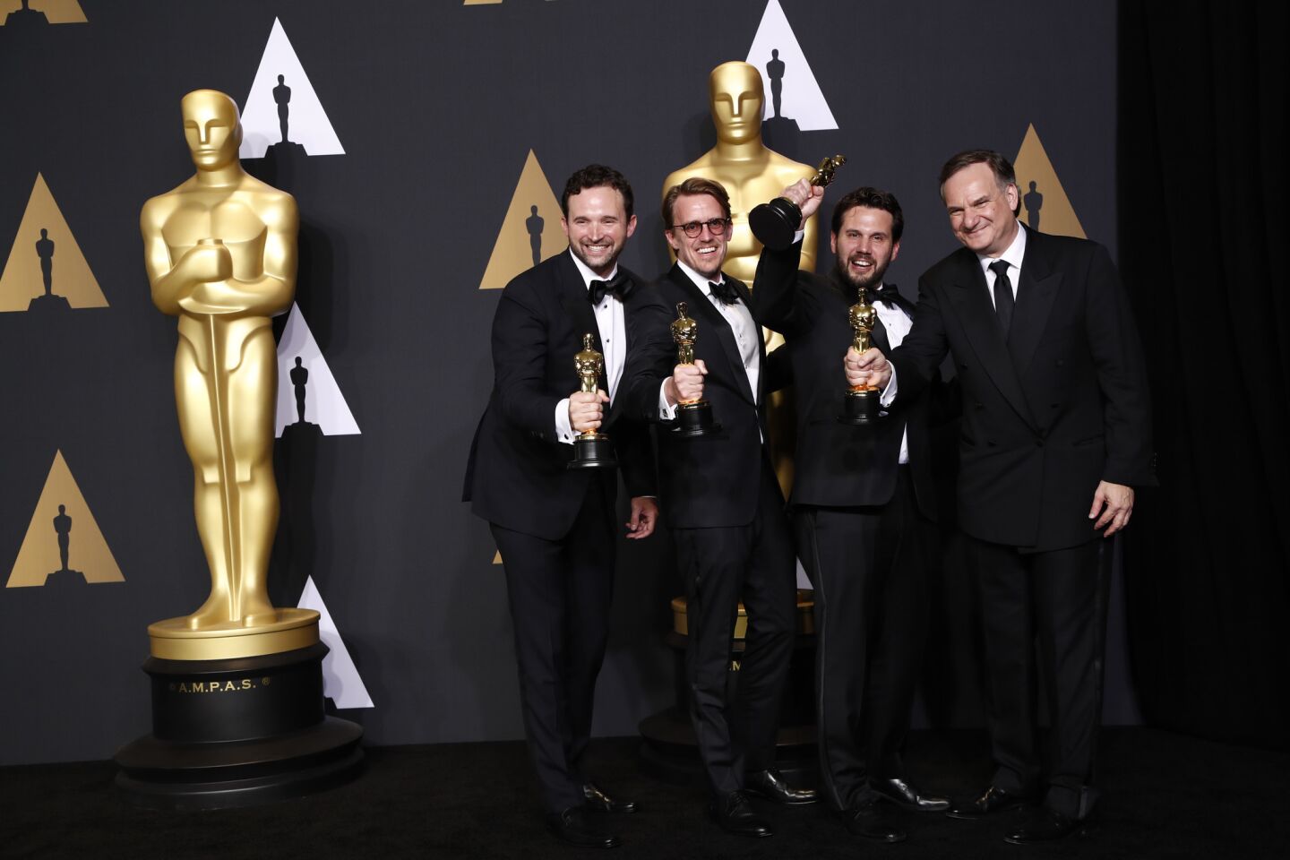 Adam Valdez, Andrew R. Jones, Dan Lemmon and Robert Legato pose with their visual effects Oscars for "The Jungle Book."