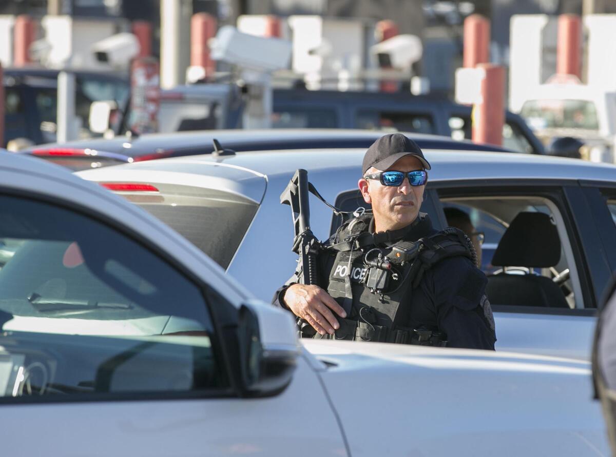 SAN DIEGO, CA. DEC 17, 2018,-CBP officers showed up in force after the group of Central American Refugees sat down in US territory outside of the turnstile gate at the Otay Mesa Port of Entry. A group of about 15 Central American caravan members accompanied by lawyers and two US Congressional Members presented themselves at the Otay Mesa Port of Entry where the Immigrants asked for asylum. They sat outside of the turnstiles which are not exactly on the US Border. They were blocked in there by US citizen volunteers so they couldn't be pushed back in to Mexico. PHOTO/JOHN GIBBINS Staff photographer, San Diego Union-Tribune. ©2018