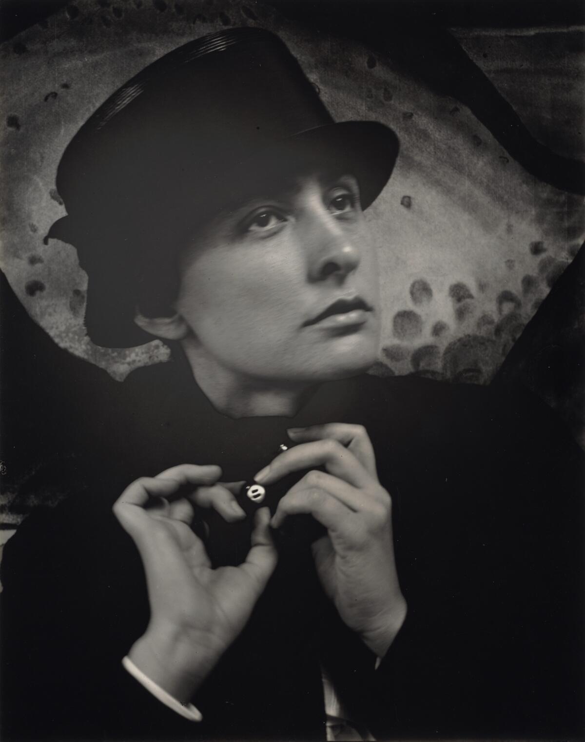 A black-and-white photograph of a young woman wearing a hat.