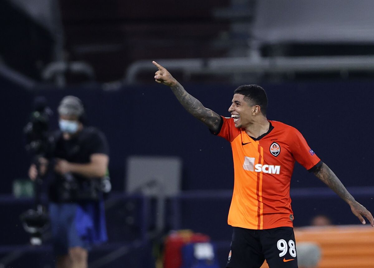 Shakhtar's Dodo celebrates after scoring his side's fourth goal during the Europa League quarter finals soccer match between FC Shakhtar Donetsk and FC Basel at the Veltins-Arena in Gelsenkirchen, Germany, Tuesday, Aug. 11, 2020. (Wolgang Rattay/Pool Photo via AP)