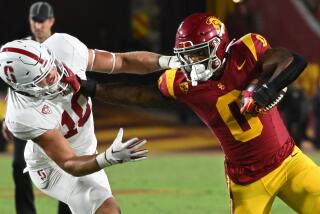 USC running back MarShawn Lloyd stiff arms Sanford linebacker Spencer Jorgensen as he carries the ball