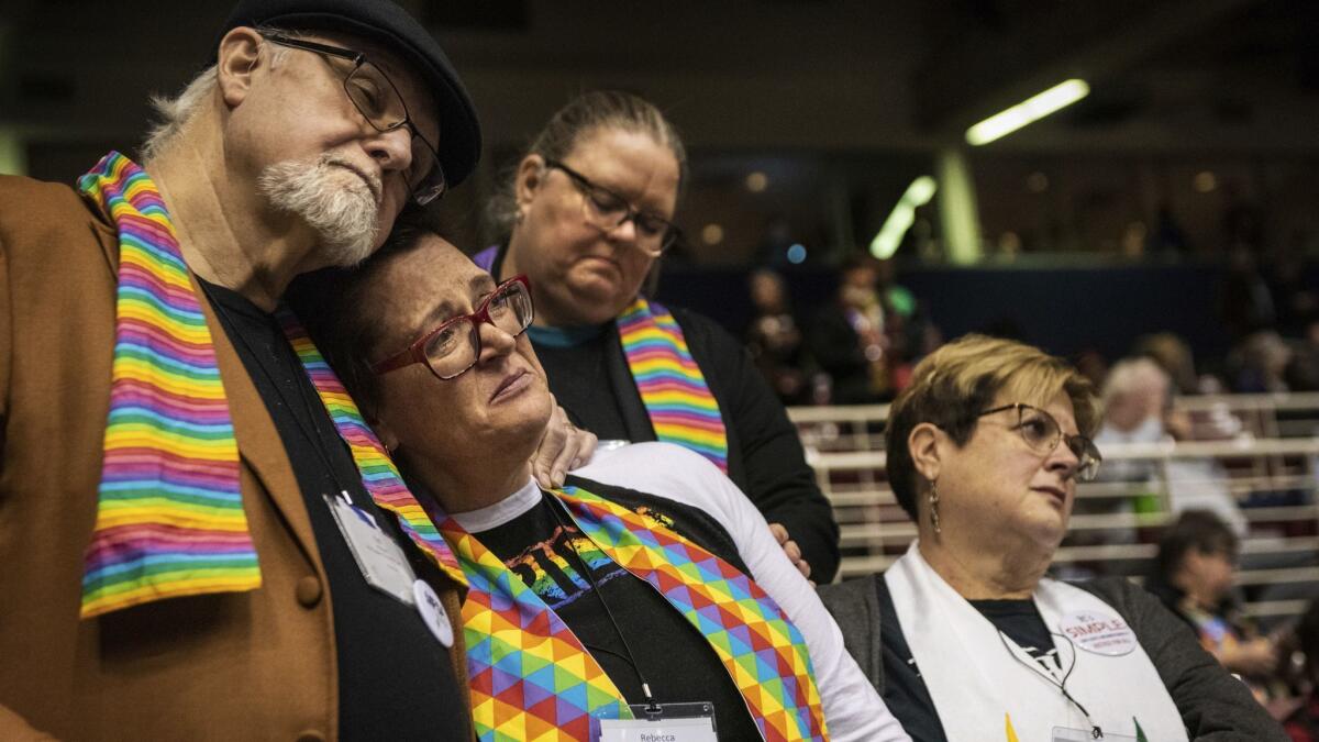 Ed Rowe, left, Rebecca Wilson, Robin Hager and Jill Zundel react to the defeat of a proposal that would allow LGBT clergy and same-sex marriage within the United Methodist Church at the denomination's 2019 Special Session of the General Conference in St. Louis on Tuesday.