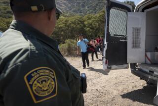 A Border Patrol agent leads a group of migrants seeking asylum towards a van to be transported and processed, Wednesday, June 5, 2024, near Dulzura, Calif. President Joe Biden on Tuesday unveiled plans to enact immediate significant restrictions on migrants seeking asylum at the U.S.-Mexico border as the White House tries to neutralize immigration as a political liability ahead of the November elections. (AP Photo/Gregory Bull)