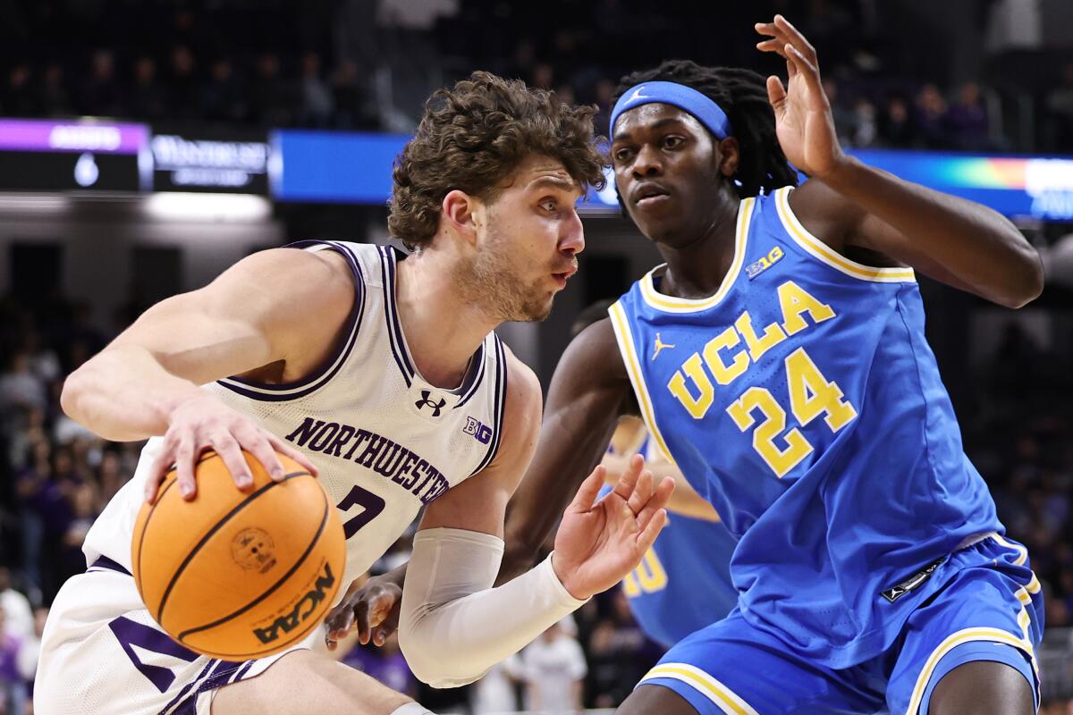 Nick Martinelli of Northwestern dribbles past William Kyle III in the first half.