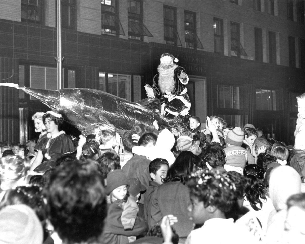 November 1959 -- ST. NICK - Hundreds of squealing youngsters close in on Santa's silvery missile float a moment after it stopped in an unplanned but highly approved manner at 5th Avenue and Broadway for several minutes during the Downtown Association's parade last night.