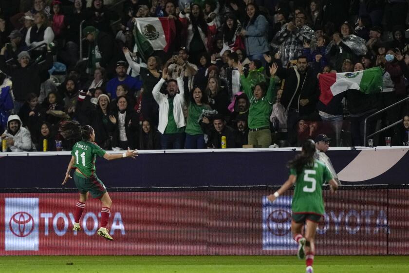 Mexico midfielder Jacqueline Ovalle (11) celebrates after scoring as Mexico defender Karen Luna (5) runs during a CONCACAF Gold Cup women's soccer tournament match against the United States, Monday, Feb. 26, 2024, in Carson, Calif. (AP Photo/Ryan Sun)