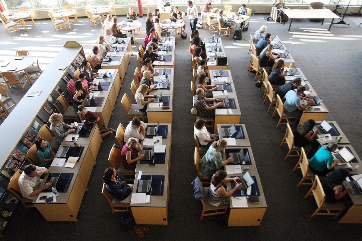 Parents sit with Chromebooks for a "Tech Academy" in the Information Resource Center at La Cañada High School on Monday, Aug. 1, 2016. The goal is to bring parents up-to-speed with the technology being used in the LCUSD both inside, and outside, the classroom.