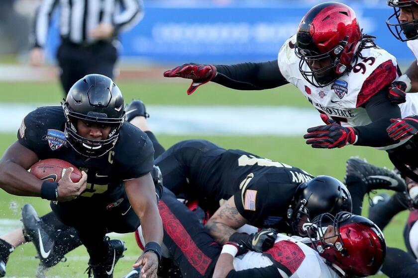 FORT WORTH, TX - DECEMBER 23: Ahmad Bradshaw #17 of the Army Black Knights carries the ball against Noble Hall #95 of the San Diego State Aztecs in the first half of the Lockheed Martin Armed Forces Bowl at Amon G. Carter Stadium on December 23, 2017 in Fort Worth, Texas. (Photo by Tom Pennington/Getty Images) ** OUTS - ELSENT, FPG, CM - OUTS * NM, PH, VA if sourced by CT, LA or MoD **