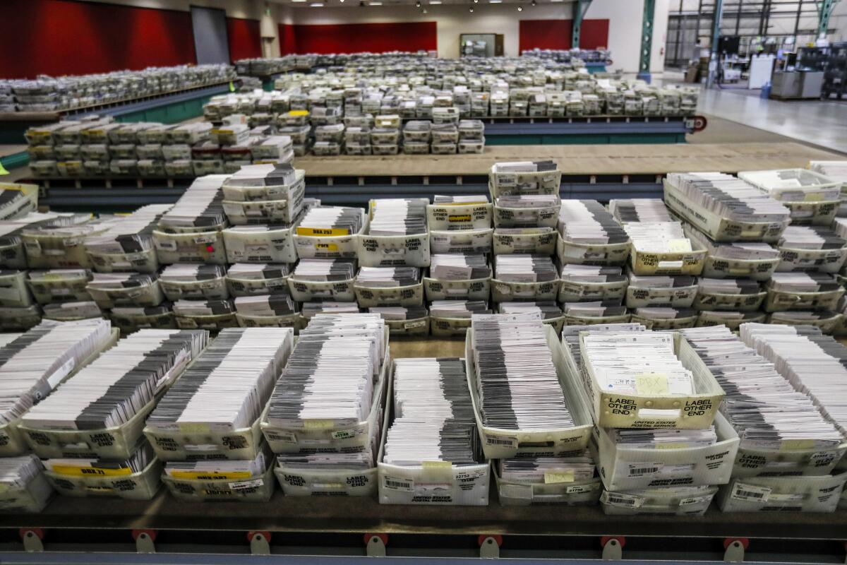 Vast rows of boxes containing absentee ballots in a warehouse space