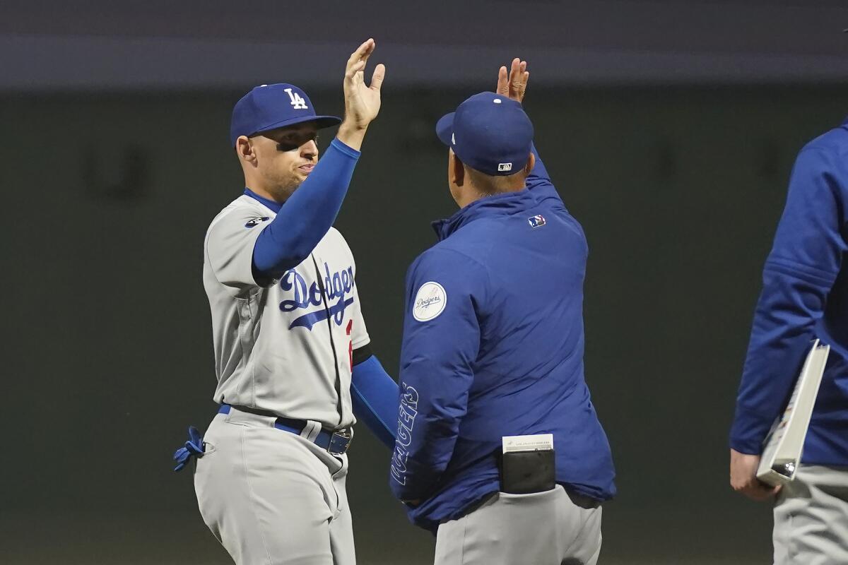 Los Angeles Dodgers' Trayce Thompson, left, celebrates with manager Dave Roberts after the Dodgers defeated the San Francisco Giants in a baseball game in San Francisco, Saturday, Sept. 17, 2022. (AP Photo/Jeff Chiu)