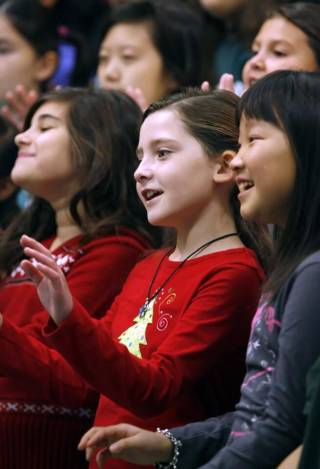 Students, including 3rd grader Ashlin Cuesta, 8, center, sing holiday songs during the Dunsmore Elementary School's annual Holiday Concert at the La Crescenta school on Tuesday, December 6, 2011.