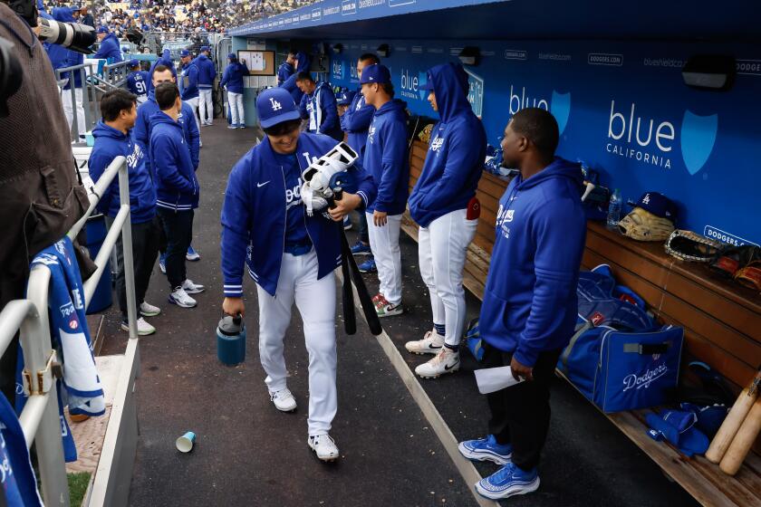 Los Angeles, CA - March 24: Los Angeles Dodgers designated hitter Shohei Ohtani (17) exits the dugout during the Los Angeles Dodgers vs. Los Angeles Angels spring training game at Dodger Stadium on Sunday, March 24, 2024 in Los Angeles, CA. (Jason Armond / Los Angeles Times)