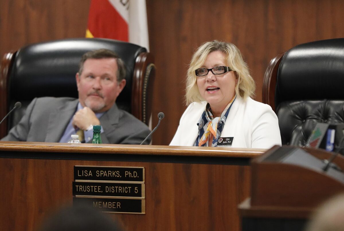 Trustee Lisa Sparks Ph.D speaks during a recent O.C. Board of Education forum as vice president Ken Williams listens.