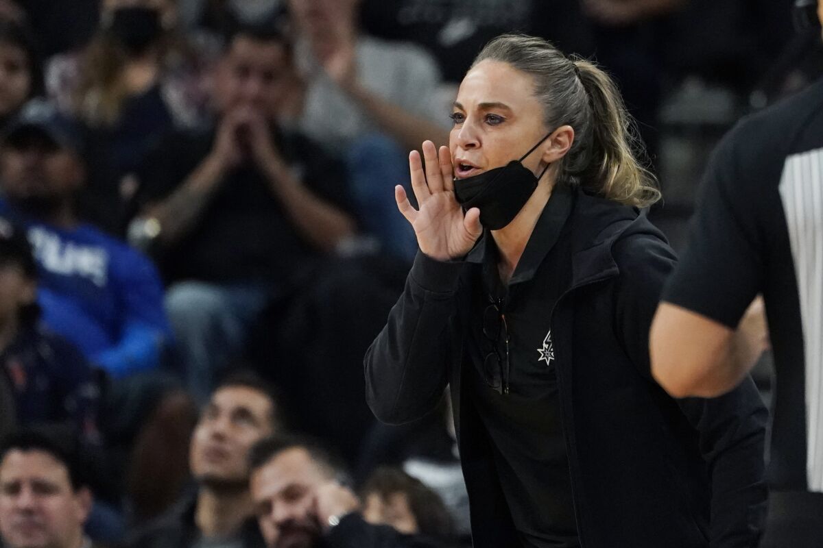 FILE - San Antonio Spurs assistant coach Becky Hammon during the first half of an NBA basketball game against the Dallas Mavericks, Friday, Nov. 12, 2021, in San Antonio. Hammon is finalizing a deal to become the next coach of the Las Vegas Aces. A person familiar with the situation confirmed the move to The Associated Press on condition of anonymity because no official announcement has been made. She’s expected to be the highest paid coach in the WNBA, earning way more than the highest paid player in the league. (AP Photo/Eric Gay, File)