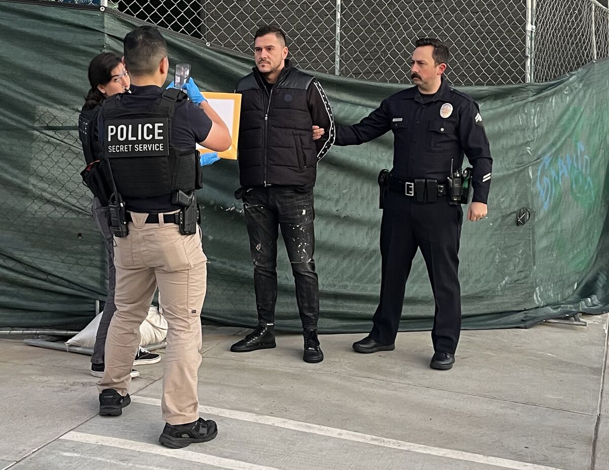 Los Angeles police and federal officers arrest a man suspected of committing EBT card fraud at an ATM.