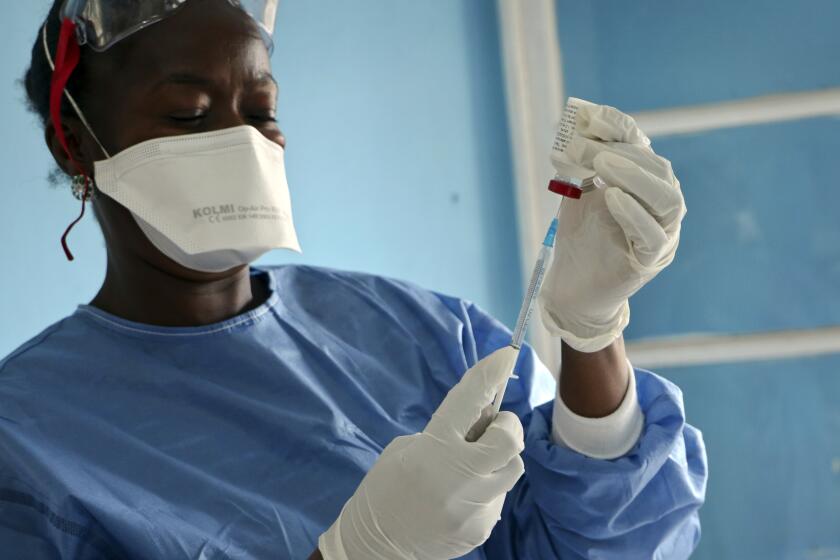 In this Wednesday, May 30, 2018 file photo a healthcare worker from the World Health Organization prepares vaccines to give to front line aid workers, in Mbandaka, Congo. The World Health Organization says Monday, Sept. 23, 2019 Congo will start using a second experimental Ebola vaccine, as efforts to stop the spiraling outbreak are stalled and Doctors Without Borders criticizes vaccination efforts to date. (AP Photo/(AP Photo/Sam Mednick, file)