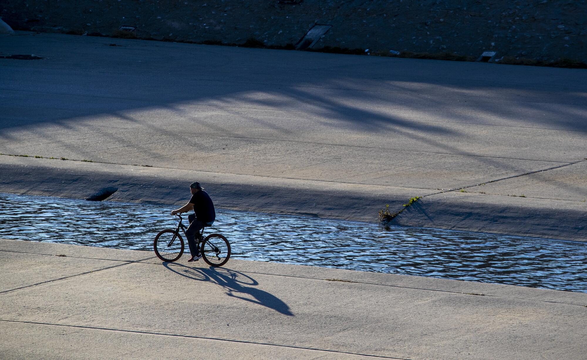  A cyclist rides in the Los Angeles River Sunday, Jan. 10, 2021 in South Gate.