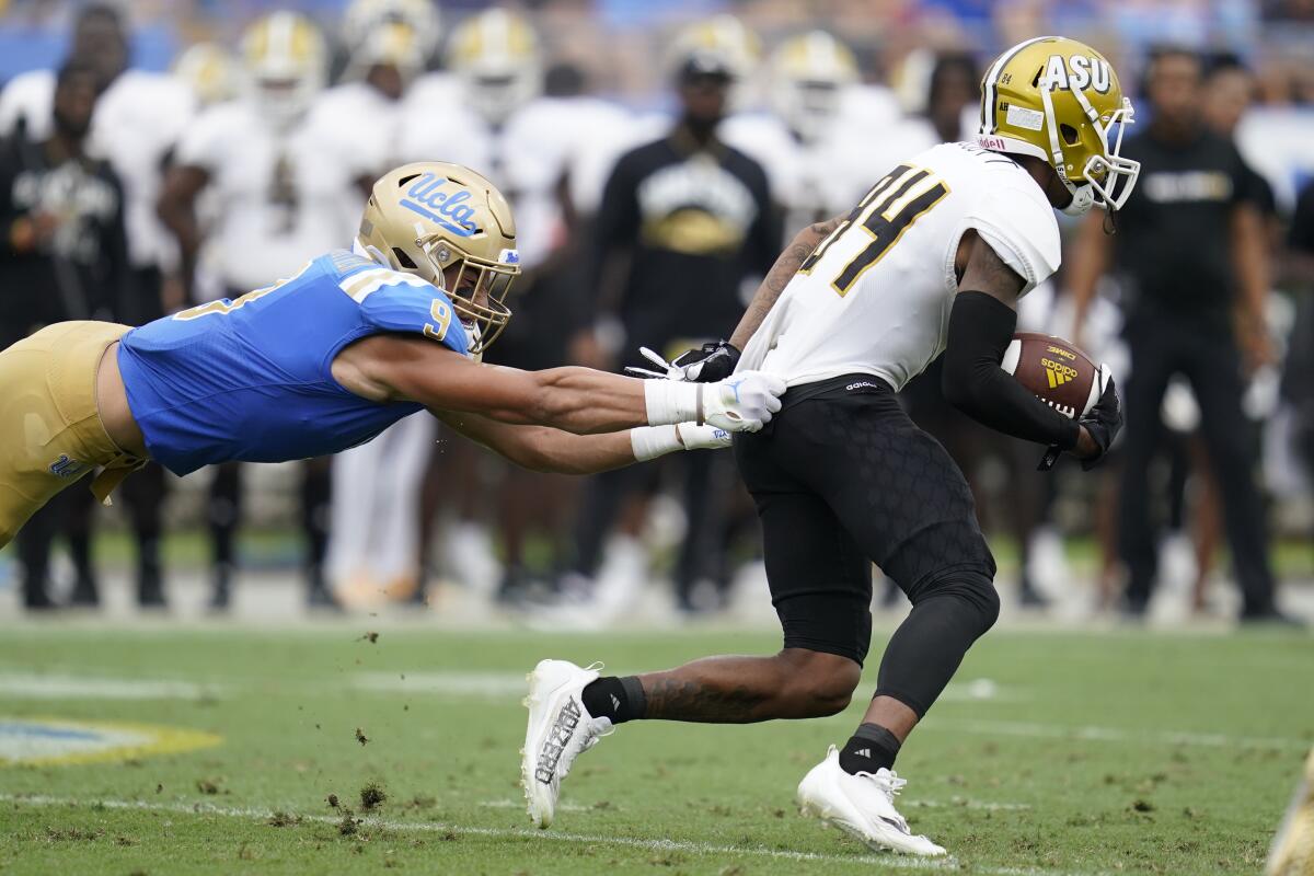 UCLA linebacker Choe Bryant-Strother tackles Alabama State wide receiver Isaiah Scott 