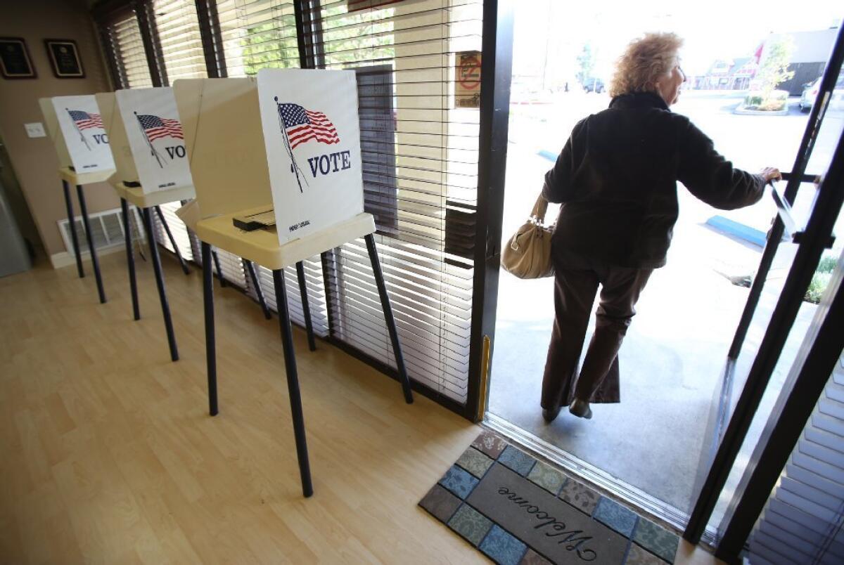 A voter leaves after casting her ballot in Encino on election day in Los Angeles on March 5, 2013.