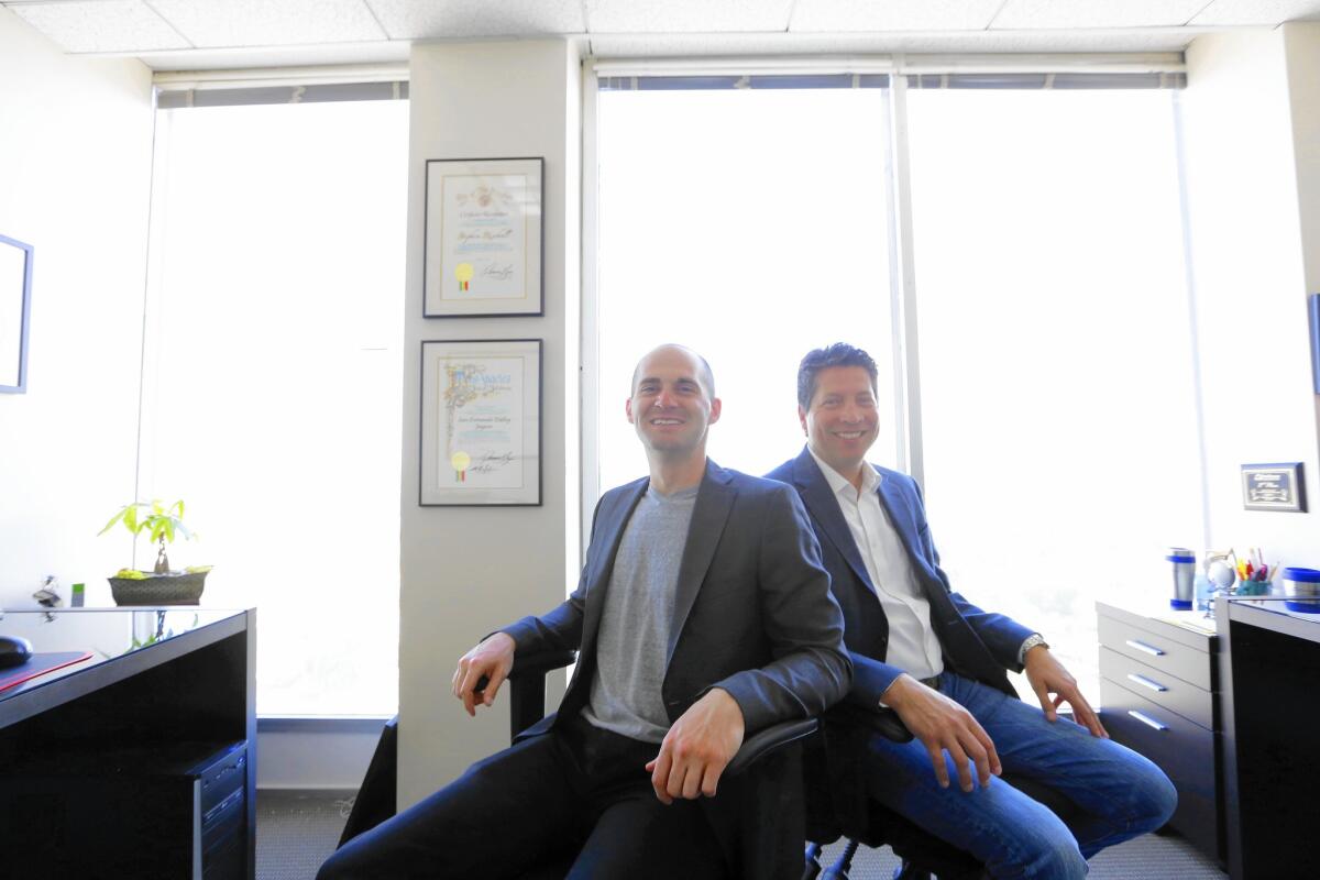 Stephen Rischall, left, and Matt Stadelman co-founded 1080 Financial Group, a small Sherman Oaks firm that promises to act in the best interest of the client.