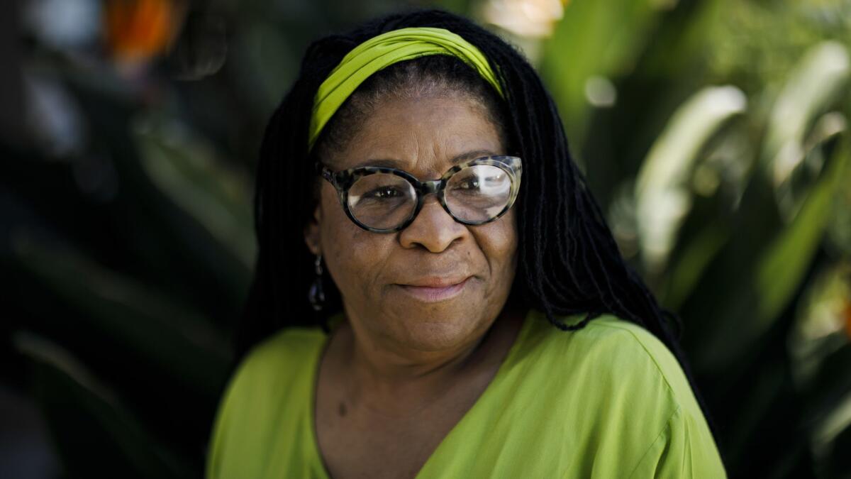 Prison activist Susan Burton stands outside one of five South Los Angeles homes she operates to help women leaving prison to reenter society and avoid further incarceration.