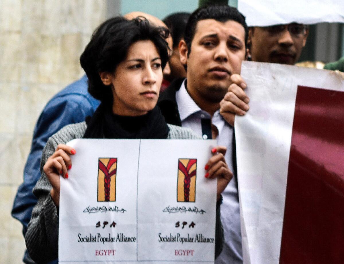 In this Jan. 24, 2015, photo, 32-year-old Shaimaa Sabbagh holds a poster during a protest in downtown Cairo.