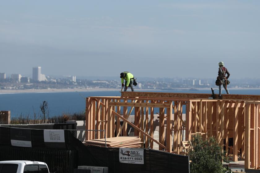 Malibu, CA - October 16: Construction workers rebuild a home with an ocean view amid cleared lots and sparse construction after the Palisades Fire in the Sunset Mesa neighborhood of eastern Malibu Tuesday, Oct. 21, 2025. (Allen J. Schaben / Los Angeles Times)