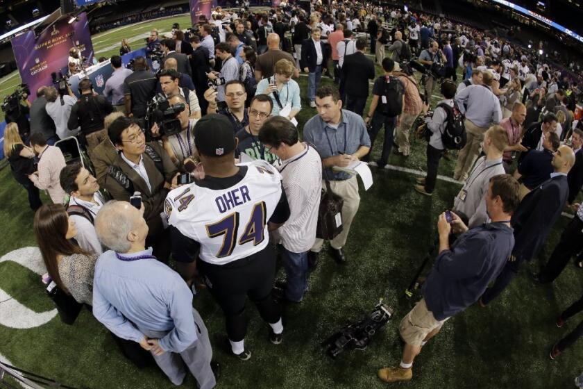 Michael Oher speaks to the assembled media on Tuesday.