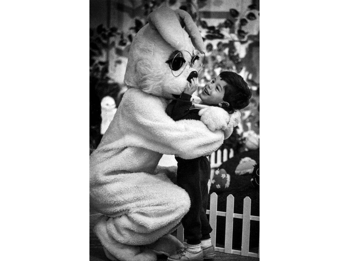 March 21, 1991: Anthony Leoni, 3, of Bellflower, squeezes the nose of the Easter Bunny at Los Cerritos Center.