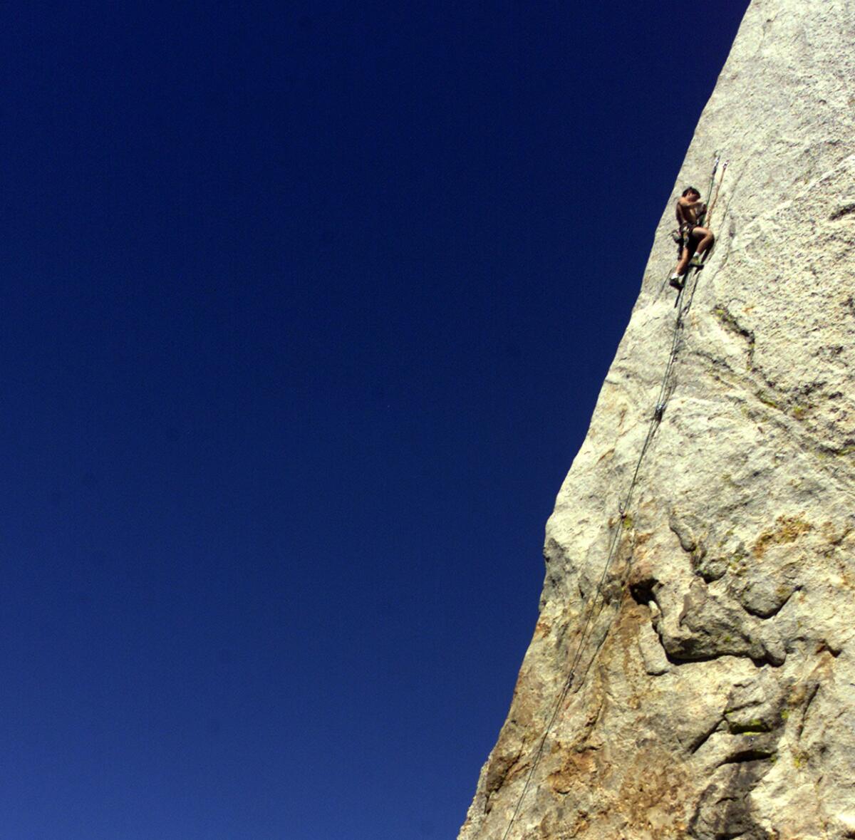 Climber works his way toward the edge on Tahquitz Rock in Idyllwild in this file photo.