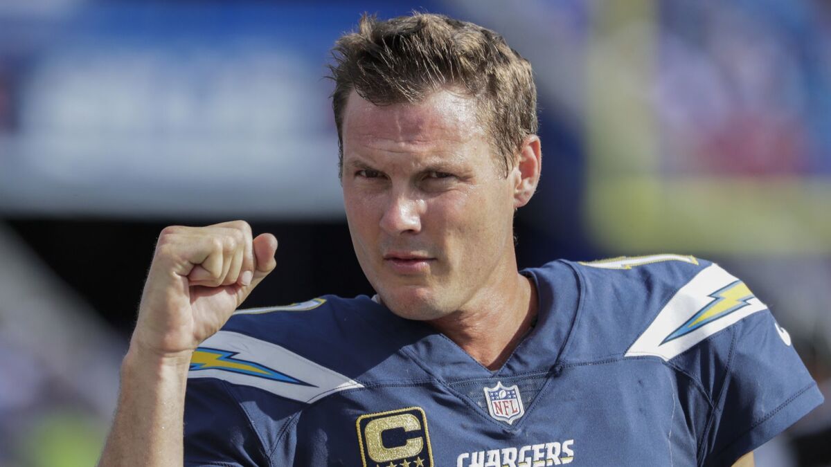 Chargers quarterback Philip Rivers shows a clenched fist to a handful of fans as the end of a 31-20 win over the Buffalo Bills.