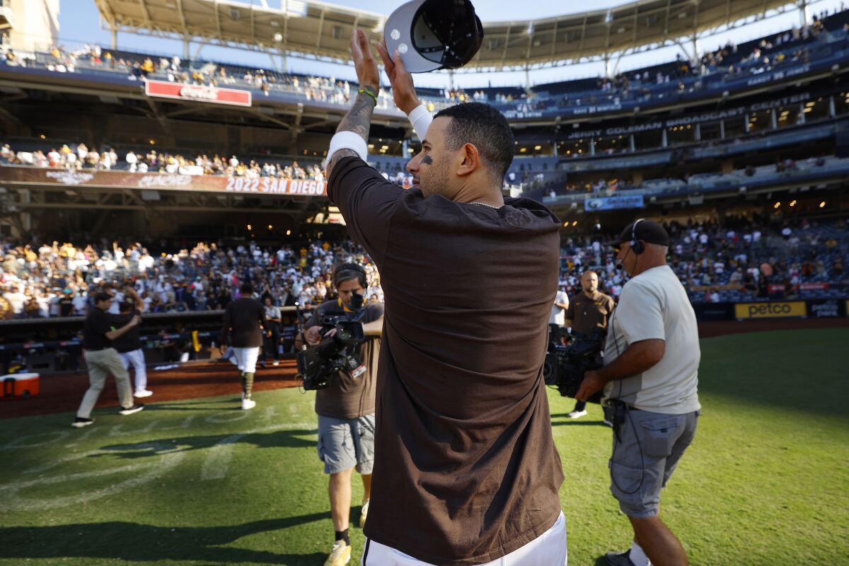 The Padres' Manny Machado salutes fans after the team clinched a wild-card playoff spot in 2022 