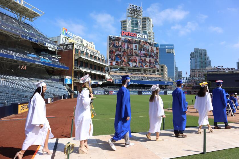 La Jolla Country Day School seniors file onto the field at Petco Park in San Diego for their graduation ceremony May 28.