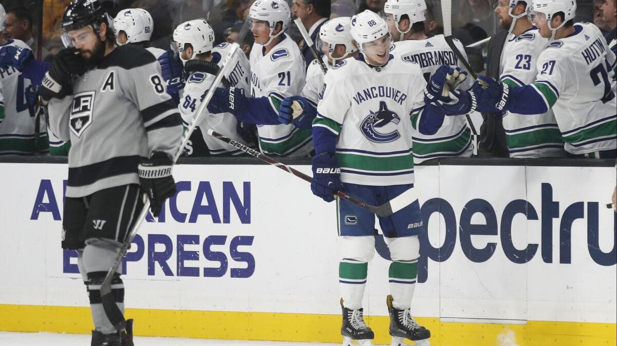 The Vancouver Canucks' Adam Gaudette celebrates his goal with teammates as the Kings' Drew Doughty skates near them during their game at Staples Center on Nov. 24.