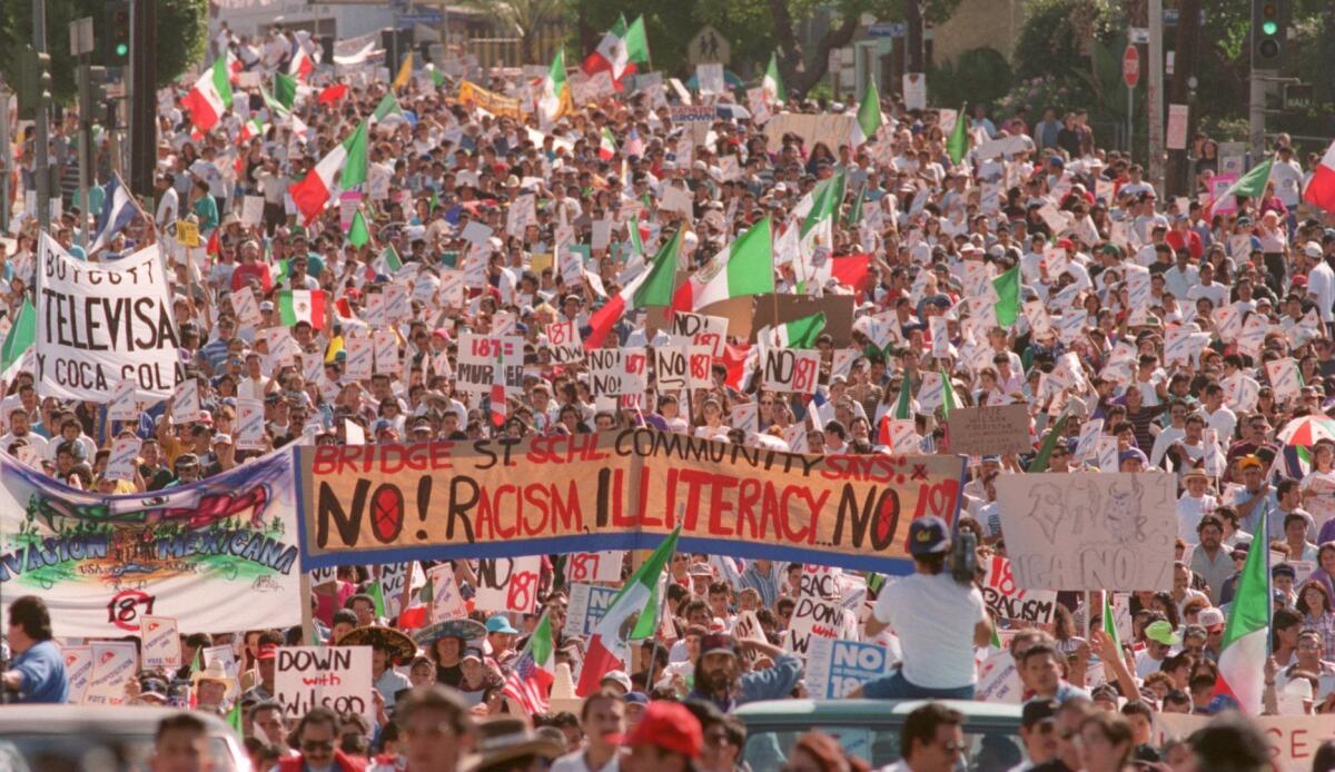 Thousands of protesters march along Cesar Chavez Boulevard on Oct. 16, 1994, denouncing Proposition 187.