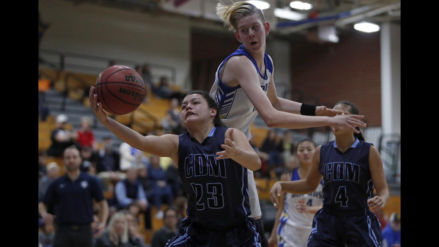 Corona del Mar High's Trasara Alexander, bottom, grabs a defensive rebound against Fountain Valley's Zoe Ziegler, top, during the first half in a Sunset Conference crossover game on Thursday, January 3, 2019.
