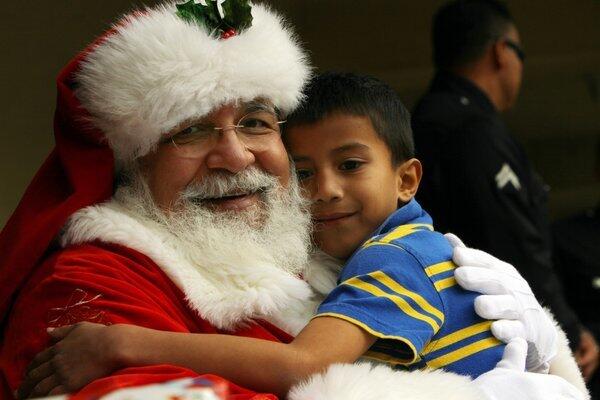 Santa Claus, a.k.a. David Fernandez, hugs Richard Fermen, 6, at Leo Politi Elementary School in Los Angeles.