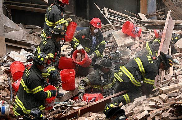 Firefighters sift through the rubble of a collapsed abandoned building on Reade Street in New York City. There was no immediate report of injuries.