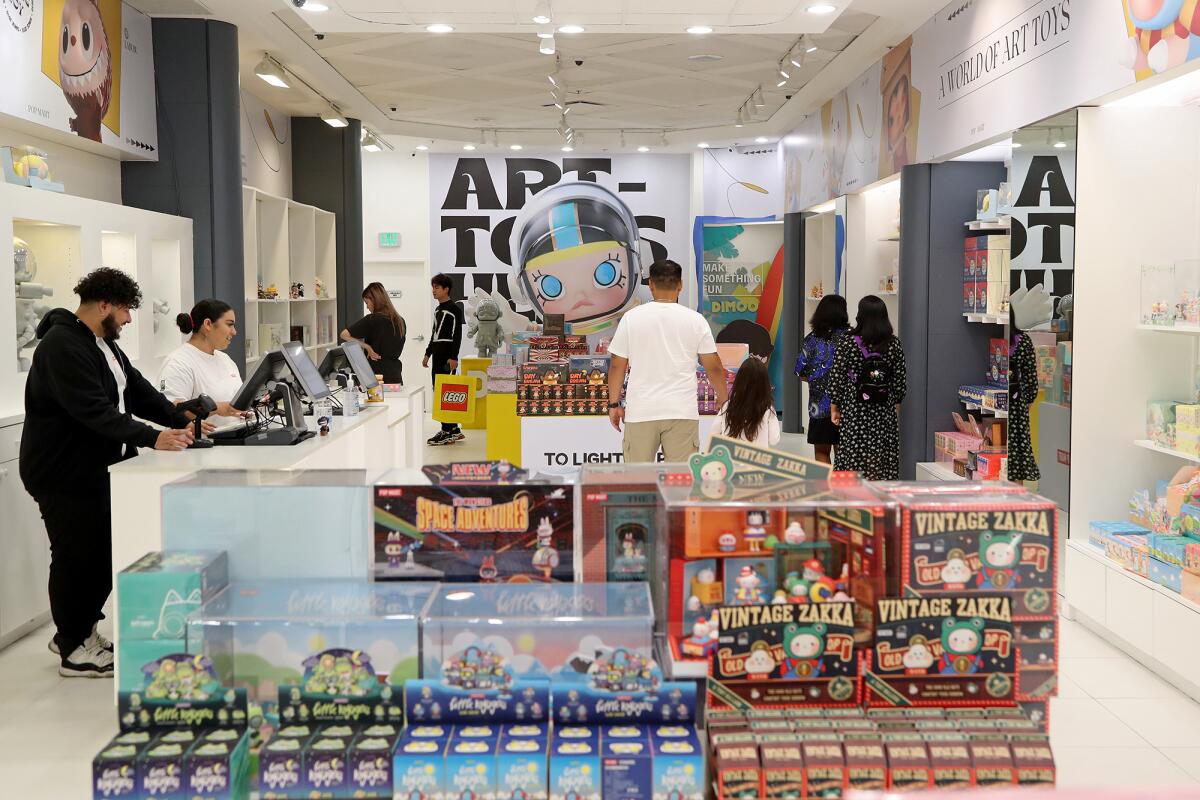 Shoppers explore trendy collectable art toys at Pop Mart at South Coast Plaza. 